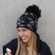 Calli camo knit bobble hat with faux fur pom pom, by Sabbot