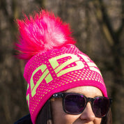 SABBOT neon logo bobble hat with black faux fur pom pom, by Sabbot