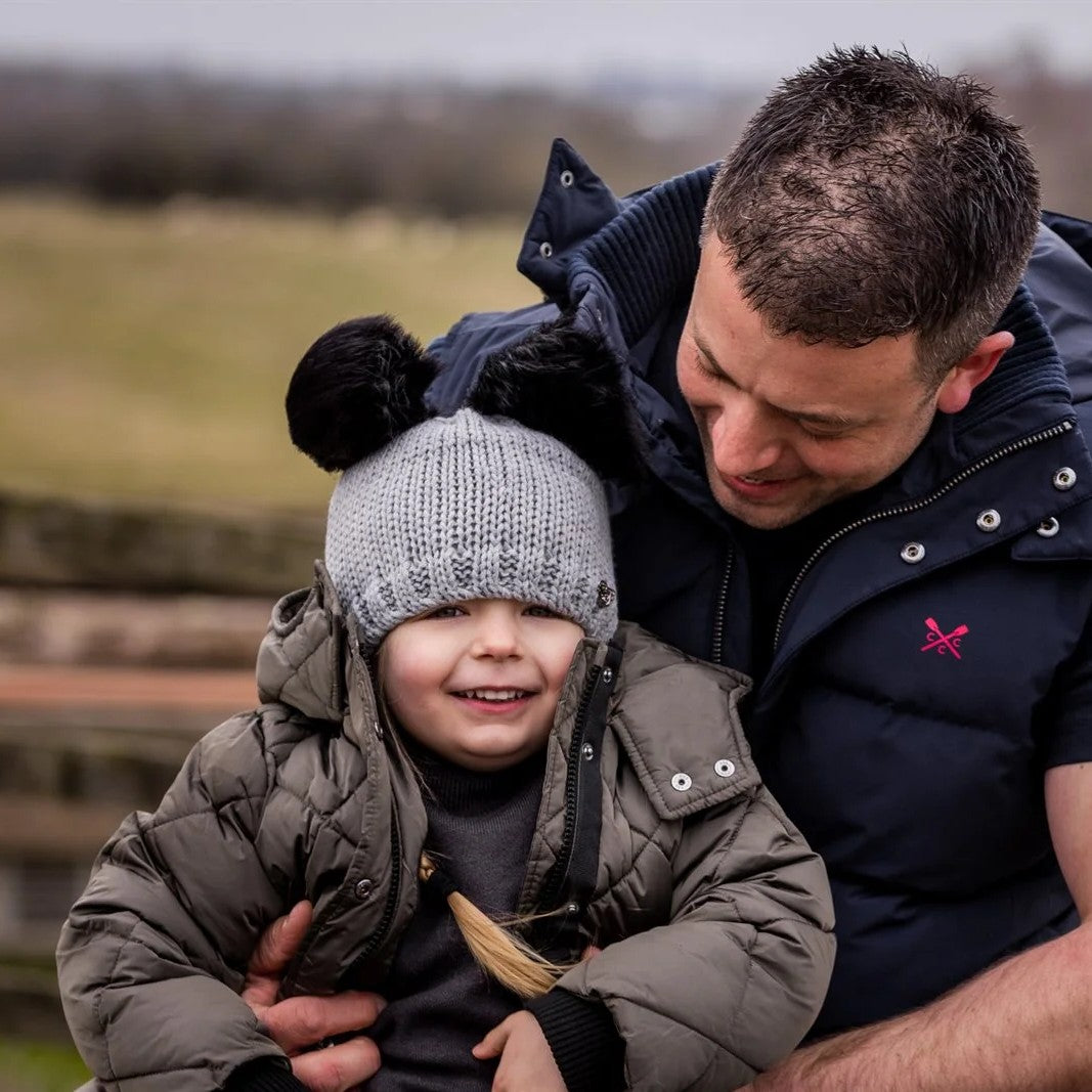 A dad and child on a canal lock wearing the Frankie Childrens Bobble Hat in Light Grey