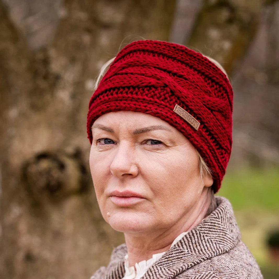 Two women in tweed jackets and riding boots wearing the Linda Headband in Burgundy