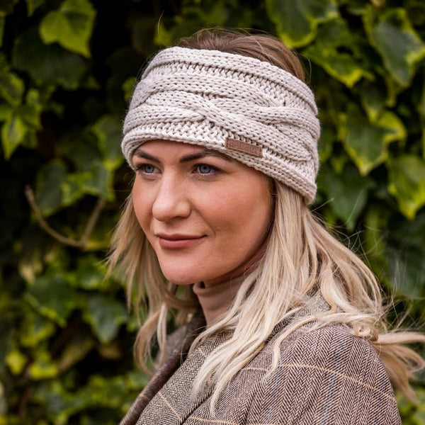 Two women in tweed jackets and riding boots wearing the Linda Headband in Cream