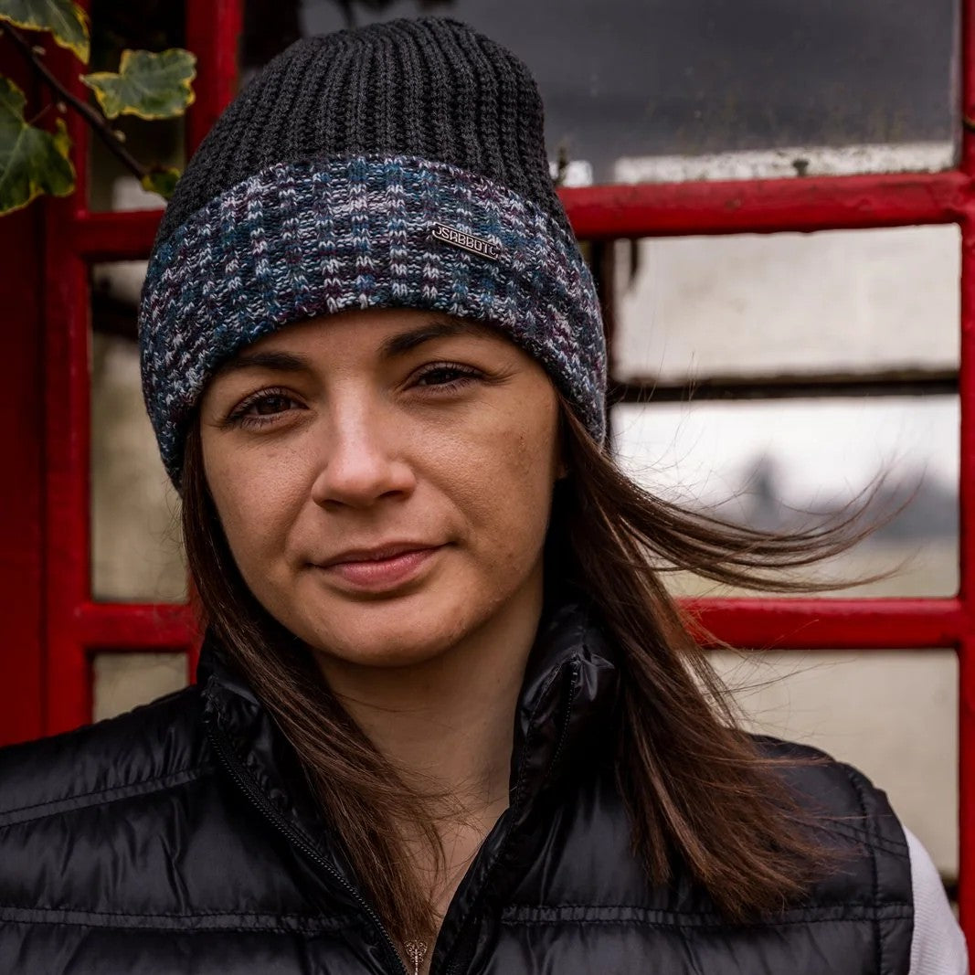 Two women by a red phone box wearing the Morgan Beanie in Black Camo