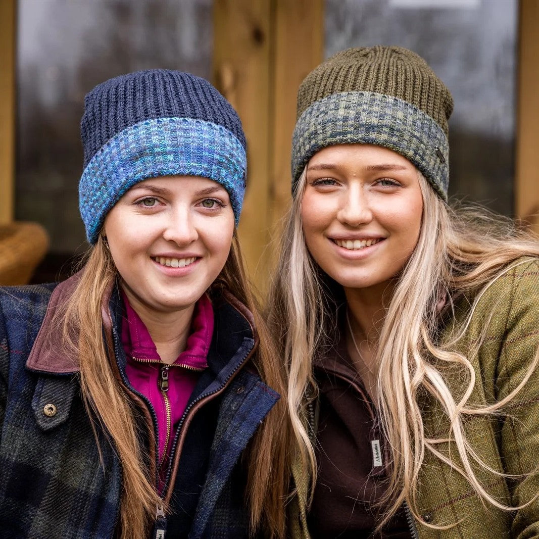 Two women in marl-cuff beanies on cabin steps wearing the Morgan Beanies in Blue Camo and Green Camo