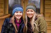 Two women in marl-cuff beanies on cabin steps wearing the Morgan Beanies in Blue Camo and Green Camo