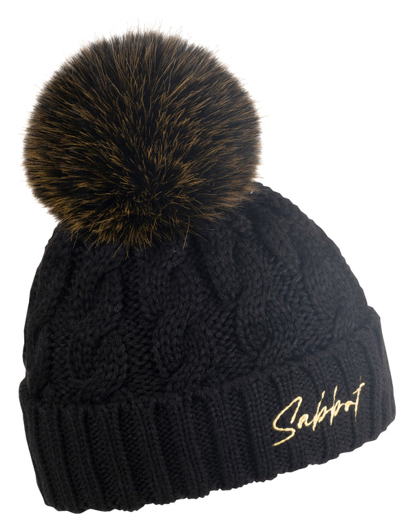 Linda black cable knit bobble hat with gold Sabbot script and brown faux fur pom pom, by Sabbot